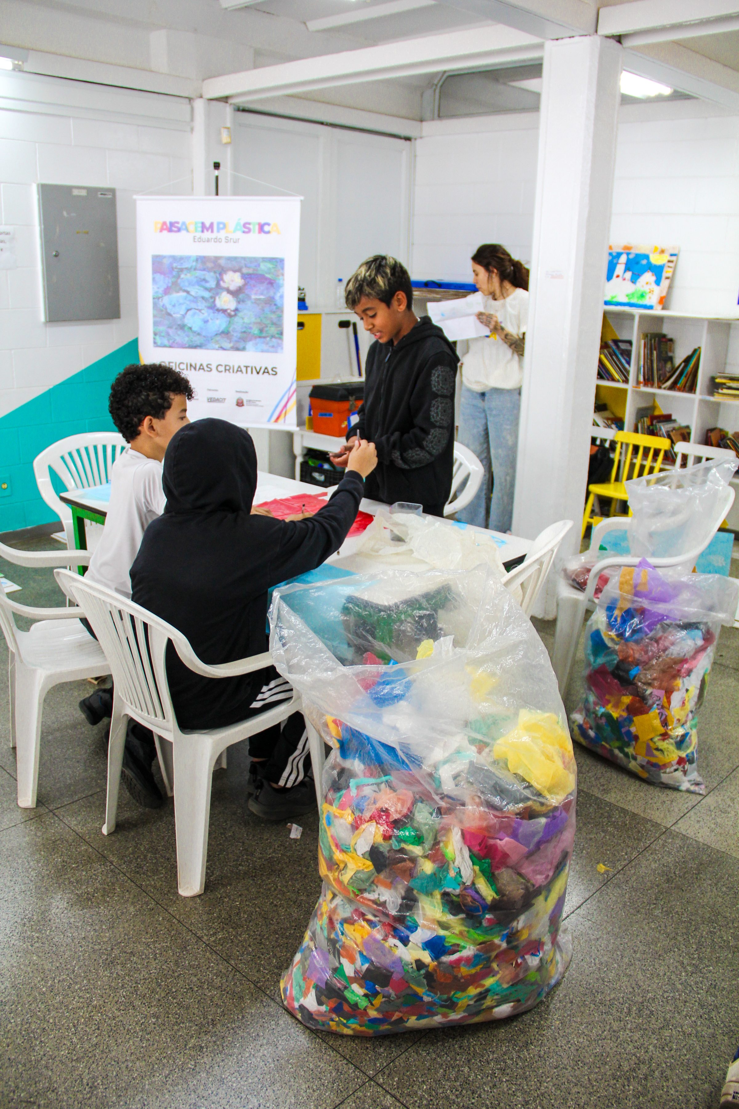 Students in the workshop, with bags of colorful plastic waste used as raw material